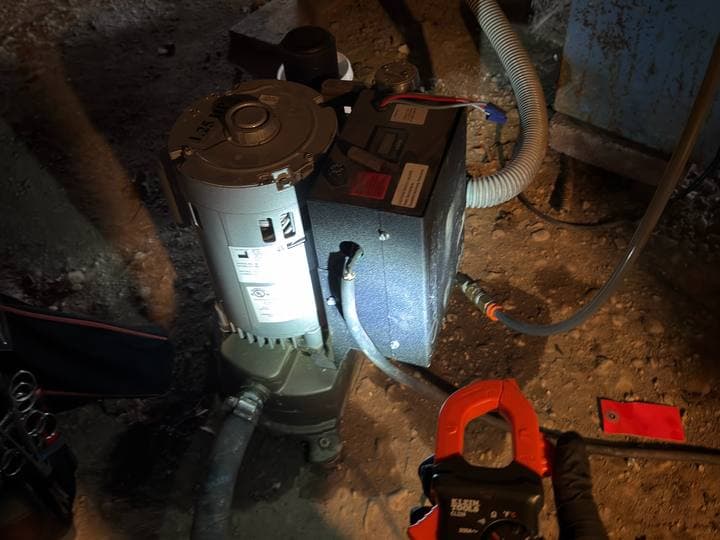 Vacuum pump under test with a clamp meter